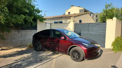 a red car parked in front of a house at Gite à moins de 10 minutes de la cité médiévale de Carcassonne in Carcassonne