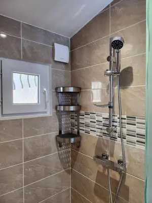 a shower with a glass door in a bathroom at Gite à moins de 10 minutes de la cité médiévale de Carcassonne in Carcassonne