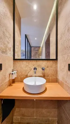 a bathroom with a white sink and a mirror at Le Relais de Diligence Balnéo & Sauna in Salsigne