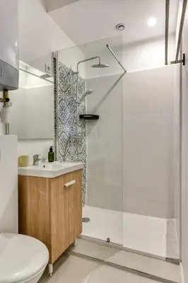 a bathroom with a shower and a toilet and a sink at L'Alchémille Terrasse Wifi in Peyriac-de-Mer