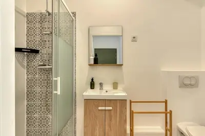 a bathroom with a sink and a shower at L'Alchémille Terrasse Wifi in Peyriac-de-Mer