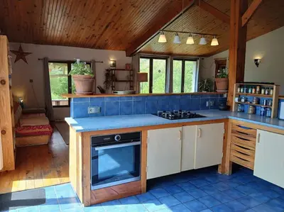 a kitchen with a stove and a blue counter top at Bright loft with mountain and nature view in Sougraigne