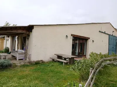 a building with a picnic bench in front of it at Bright loft with mountain and nature view in Sougraigne