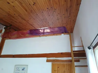 a bunk bed in a room with a wooden ceiling at Bright loft with mountain and nature view in Sougraigne