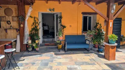 a patio with a blue chair and potted plants at Studio 35m², Terrasse & Cuisine proche Carcassonne in Montclar
