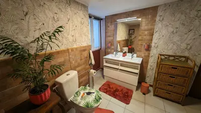 a bathroom with a toilet and a sink and a plant at Studio 35m², Terrasse & Cuisine proche Carcassonne in Montclar