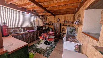 a kitchen in a cabin with wooden walls and ceilings at Studio 35m², Terrasse & Cuisine proche Carcassonne in Montclar