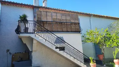 a stairway of a building with a balcony at Bel Appartement in Vinassan