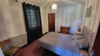 a bedroom with a bed and a dresser and a window at Bel Appartement in Vinassan