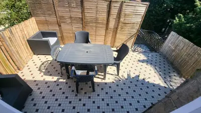 a table and chairs sitting on a patio at Bel Appartement in Vinassan
