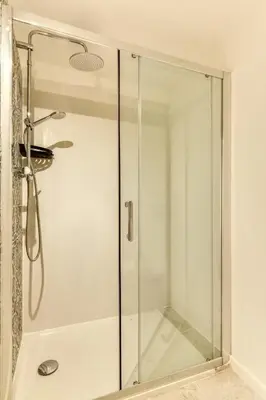 a shower with a glass door in a bathroom at Le Cyperus Appartement avec Terrasse et Wifi in Peyriac-de-Mer