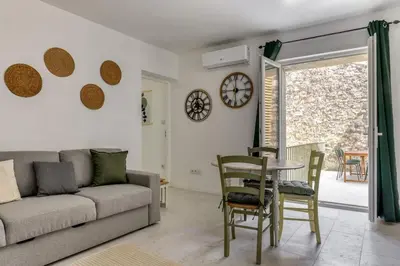 a living room with a couch and a table at Le Cyperus Appartement avec Terrasse et Wifi in Peyriac-de-Mer