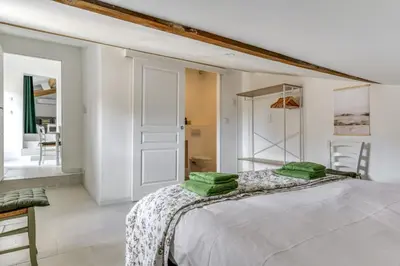 a bedroom with a bed with green pillows on it at L'Euphorbe Terrasse Wifi in Peyriac-de-Mer