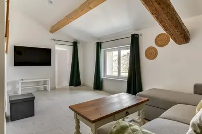 a living room with a couch and a table at L'Euphorbe Terrasse Wifi in Peyriac-de-Mer