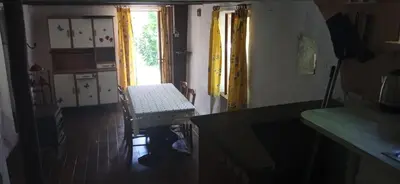 a room with a chair and a window and a door at Maison de village avec jardin in Saint-Louis-et-Parahou