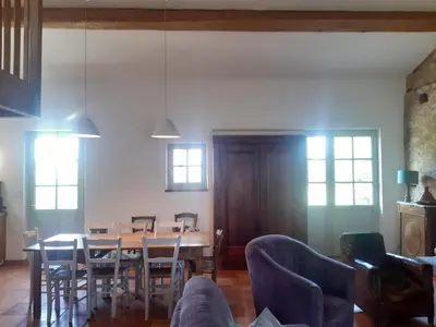 a dining room with a table and chairs at Le Pigeonnier au dessus du lac in Caraman