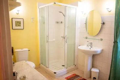 a bathroom with a shower and a sink at La Maison Bleue, nid chaleureux en bord de rivière in Rennes-les-Bains
