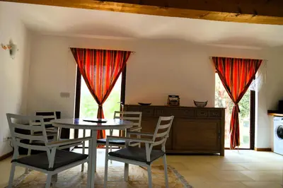 a living room with a bunk bed and a couch at Ailleursland in Montalba-le-Château