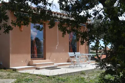 a bathroom with a shower with a sink and a window at Ailleursland in Montalba-le-Château