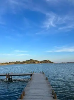a dock in the middle of a large body of water at Charmante maison de village in Peyriac-de-Mer