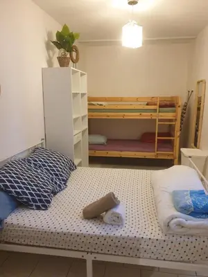 a bedroom with a bed and bunk beds in it at Maison Chevalier in Narbonne