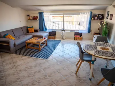 a living room with a couch and a table at Maison Chevalier in Narbonne