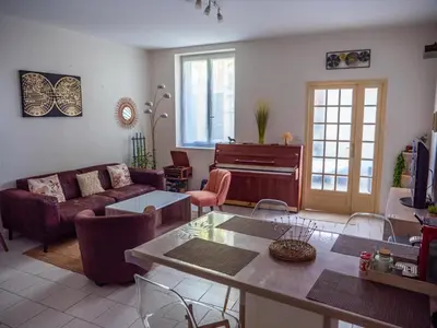 a living room with a couch and a table at Maison Chevalier in Narbonne