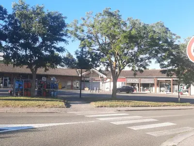an empty street in front of a store at Jolie villa avec piscine in Palaja
