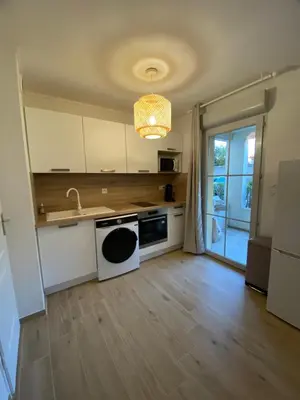 a kitchen with a sink and a stove at Appartement Carcassonne résidence capucins in Carcassonne