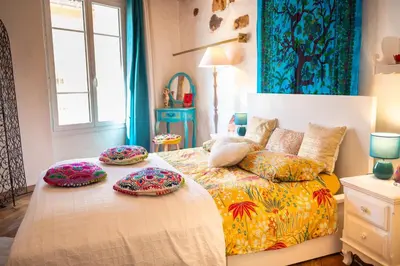 a bedroom with a bed with two pillows on it at Petite Maison de Resource avec Cuisine in Rennes-les-Bains