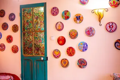 a wall with plates on a wall with a door at Petite Maison de Resource avec Cuisine in Rennes-les-Bains