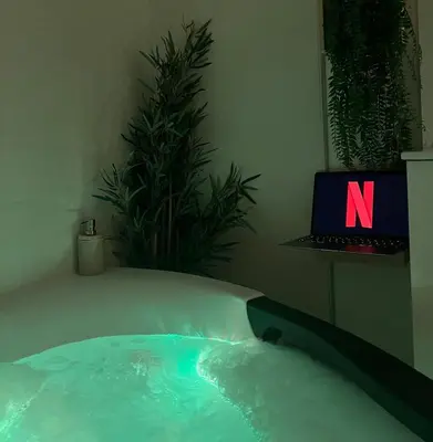 a jacuzzi tub with a laptop in a room at Le Somptueux, Cosy / Balnéo in Carcassonne