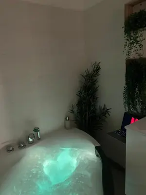 a bath tub filled with water in a room at Le Somptueux, Cosy / Balnéo in Carcassonne