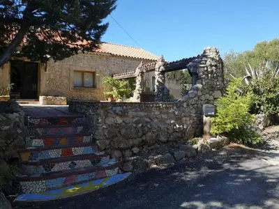 a stone house with stairs in front of it at Domaine de La Pierre Chaude in Portel-des-Corbières