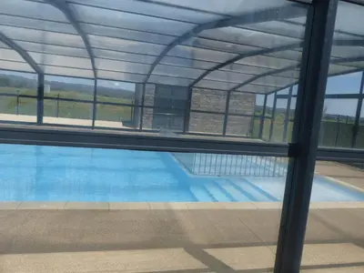 a view of a swimming pool through a window at Cottage du Lac in Olonzac