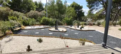 a garden with a park with people walking around at Cottage du Lac in Olonzac