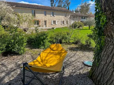 a yellow tent sitting in the yard of a house at Domaine du Léou in Fiac