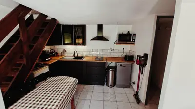 a small kitchen with a sink and a refrigerator at pavillon 45m2, 2 Chambres, 1 salon cuisine, 1sdb in Gruissan
