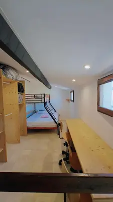 a room with a desk and a bunk bed at pavillon 45m2, 2 Chambres, 1 salon cuisine, 1sdb in Gruissan