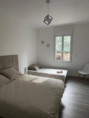 a bedroom with two beds and a window at Le Carmagnol in Caramany