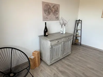 a bedroom with a white bed with a wooden headboard at Le Carmagnol in Caramany