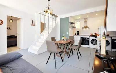 a kitchen and dining room with a table and chairs at Nice Home In Bizanet With Kitchen in Bizanet