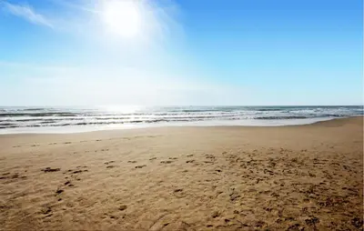 a beach with footprints in the sand and the ocean at Nice Home In Bizanet With Kitchen in Bizanet