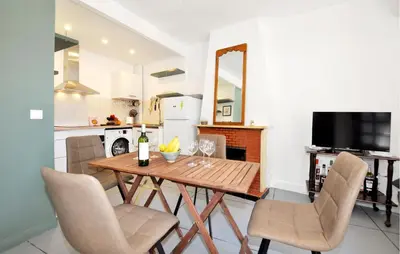 a kitchen and dining room with a wooden table and chairs at Nice Home In Bizanet With Kitchen in Bizanet