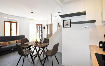 a dining room and living room with a table and chairs at Nice Home In Bizanet With Kitchen in Bizanet
