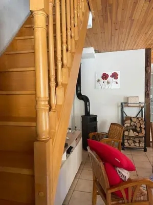a staircase with a red pillow on a chair at Charmante maison à la montagne in Belcaire