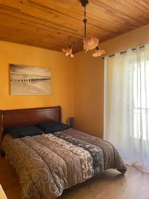 a bedroom with a bed and a window at Charmante maison à la montagne in Belcaire