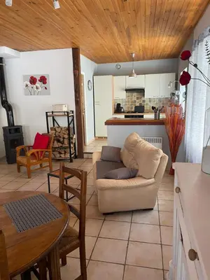 a living room with a couch and a table at Charmante maison à la montagne in Belcaire