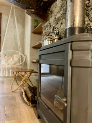 an old woodburning stove in a room at Parenthèse en Forêt - Gîte Hautbois, Sidobre in Le Bez