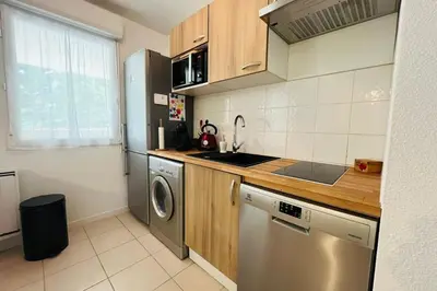 a kitchen with a sink and a dishwasher at Le Rimini Terrasse Wifi Parking privé in Narbonne